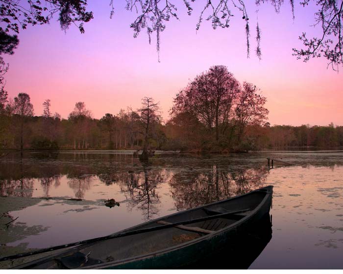 Sunset over the water photos supplied by Magnolia Plantation and Gardens